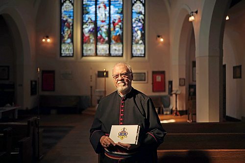 13092022
The Very Reverend William G. Cliff, VII Bishop of Brandon, holds a book of condolence for Her Majesty Queen Elizabeth II at St. Matthew's Anglican Cathedral in Brandon on Tuesday. 
(Tim Smith/The Brandon Sun)