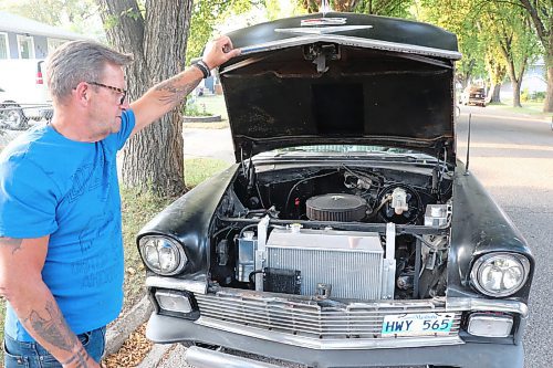 Dave DeMarce pops the hood on his 1956 Chevrolet Bel Air to check in on the 350 cubic inch engine that is powering it. DeMarce told the Sun on Wednesday that he's hoping to replace this engine with a 427 RAT motor at some point in the future. (Kyle Darbyson/The Brandon Sun) 