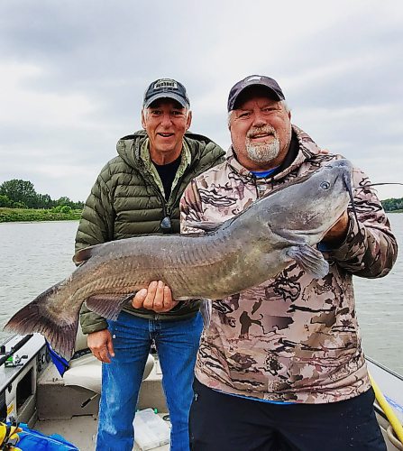 Don Lamont / Winnipeg Free Press 
Brian Haggland holding a channel catfish he caught in the Red River, with his pal Ken Bailey. 