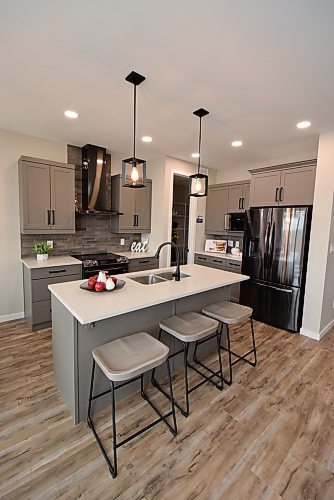 Todd Lewys / Winnipeg Free Press

Elegant yet functional, the island kitchen in this Transcona home exudes an appealing modern farmhouse feel.

