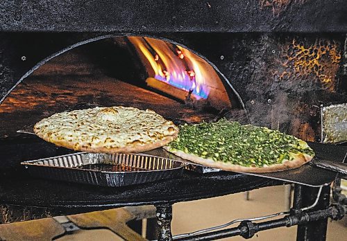 JESSICA LEE / WINNIPEG FREE PRESS

Pita pies go into the oven at Baraka Bakery on November 10, 2021.