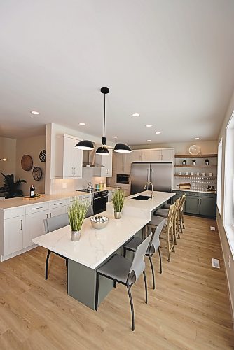 Todd Lewys / Winnipeg Free Press
A 13-foot island with a casual, attached dining table serves as the centrepiece of the smashing kitchen.