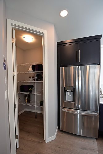 Todd Lewys / Winnipeg Free Press
The island kitchen comes equipped with a handy corner pantry with striking eight-foot door.