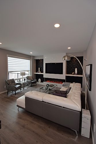 Todd Lewys / Winnipeg Free Press
The great room’s focal point is an entertainment unit with a six-foot linear fireplace and black TV nook surrounded in elegant style by a textured white-tile feature wall.