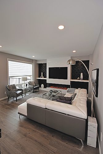 Todd Lewys / Winnipeg Free Press
The great room’s focal point is an entertainment unit with a six-foot linear fireplace and black TV nook surrounded in elegant style by a textured white-tile feature wall.