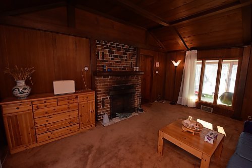 Todd Lewys / Winnipeg Free Press
Part of the original cottage, the den/sitting room is a cozy space that comes with an original wood burning fireplace with brick surround and rustic vaulted ceiling.