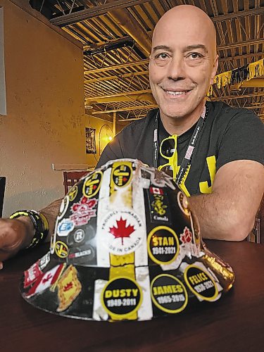 Melissa Martin / Winnipeg Free Press
Jason Allan, one of Hamilton&#x573; famed Box J Boys, sits with his Box J work hat &#x460;adorned with stickers, including memorial ones for Box J boys passed &#x460;at the Corktown Pub on Friday afternoon.