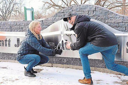 Trish and Cole Jonsson cut the ribbon on the newly minted skatepark. (Tyler Searle/Winnipeg Free Press