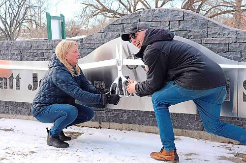 Trish and Cole Jonsson cut the ribbon on the newly minted skatepark. (Tyler Searle/Winnipeg Free Press