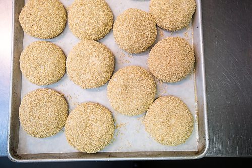 MIKAELA MACKENZIE / WINNIPEG FREE PRESS

Carter Bouchard, owner of Salt and Sunshine Bagels (a specialty bagel bakery she started on Instagram during the pandemic), whips up a batch of sesame bagels in her rented kitchen space at the Irish Association in Winnipeg on Thursday, May 20, 2021.  For Eva Wasney story.
Winnipeg Free Press 2020.