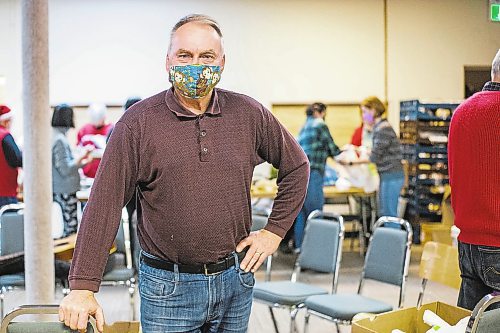 MIKAELA MACKENZIE / WINNIPEG FREE PRESS

George Hill poses for a portrait as volunteers at the Mission Baptist Church pack up hot Christmas meals in Winnipeg on Saturday, Dec. 25, 2021.  For Malak story.
Winnipeg Free Press 2021.