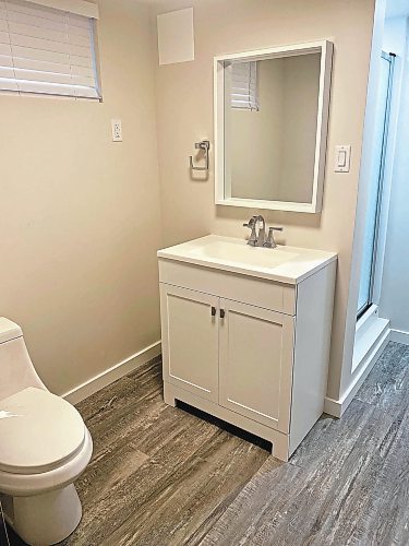 Photos by Marc LaBossiere / Winnipeg Free Press
The main area of the bathroom receives a total facelift, including new sink-vanity, faucet, mirror, toilet, venetian blinds, vinyl plank flooring and trim. 
 