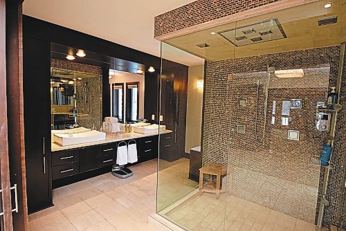 Todd Lewys / Winnipeg Free Press
A walk-in shower with tiled feature wall, body sprays, mod rain shower head outlet and built-in sound system is the highlight of the luxurious ensuite.