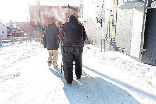 RUTH BONNEVILLE / WINNIPEG FREE PRESS



Local - Extreme Cold, COVID &amp; Homeless seeking shelter



People seek shelter at Main Street Project from the extreme cold temperatures Tuesday.



Winston Yellowback (cream pants) and his friend Peter Blackhawk make their way back to Main Street Project shelter on Tuesday.   



See Ryan Thorpe story.





Jan 26,. 2021