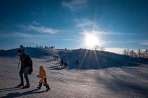 Daniel Crump / Winnipeg Free Press. People enjoy a reprieve from frigid temperatures that blanked the prairies for the last few weeks by heading to a local toboggan hill at Westview Park. February 20, 2021.