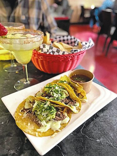 Try the birria tacos at Brandon's Sabor Latino restaurant that come with a side of spicy, soupy dipping sauce. And a margarita is highly recommended. (Shel Zolkewich/Winnipeg Free Press)