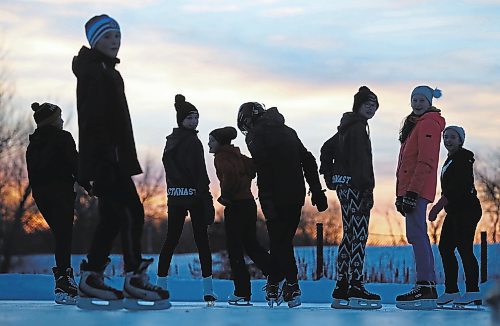 A group of friends skate at sunset at the Brandon skating Oval in this file picture. The city's skating oval includes warming shacks, music, washrooms, a light display and firepits &#x2014; all designed to create a winter wonderland feel. (File/The Brandon Sun)