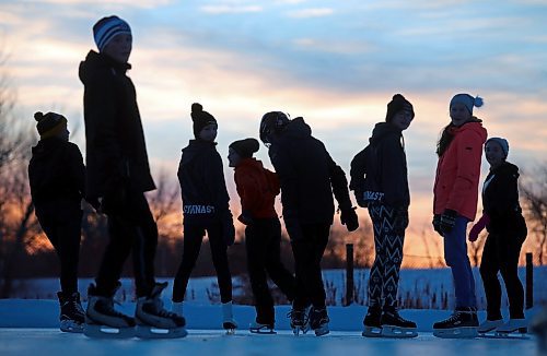 A group of friends skate at sunset at the Brandon skating Oval in this file picture. The city's skating oval includes warming shacks, music, washrooms, a light display and firepits — all designed to create a winter wonderland feel. (File/The Brandon Sun)