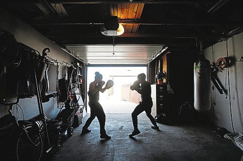 JOHN WOODS / WINNIPEG FREE PRESS

MMA fighter Brad Katona works out in his garage in Winnipeg with his girlfriend and fighter Katie Saull Wednesday, April 22, 2020. Katona was training in Ireland at Conor McGregor&#x2019;s gym in Dublin. COVID-19 has shut everything down and Katona returned to Winnipeg to train.



Reporter: Allen