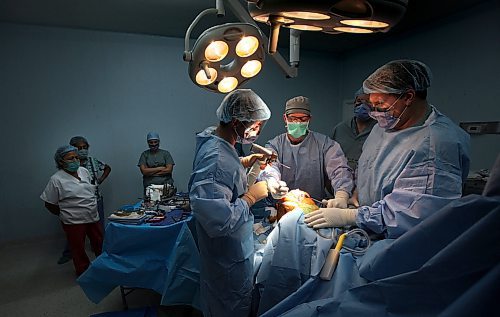 Surgeon Eric Bohm (left) Dr Jon March (center) and Dr Jason Crosby (right) lwork on replacing a knee while Nicaraguan surgical nurses watch with interest. Phil Hossack / Winnipeg Free Press October 25, 2012