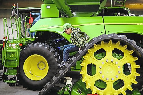 Brandon Sun 23012020
Five-year-old George Van Eaton of Maryfield, Saskatchewan climbs on a towering John Deere tread while visiting Manitoba Ag Days at the Keystone Centre with his dad on Thursday. (Tim Smith/The Brandon Sun)