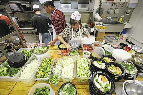 The busy kitchen at 4 Seasons Chinese Food at Southdale Centre on Dec. 18, 2015. The Chinese take-out and delivery restaurant has been in operation for almost 30 years and is extremely busy this time of year. Customers usually start placing their orders for Christmas and New Year&#x2019;s Eve in August or September. Photo by Jason Halstead/Winnipeg Free Press RE: Dave Sanderson story
