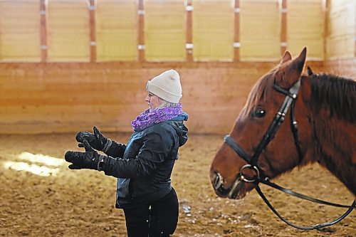 27012022
Taylor McEachern, Head Coach and Partner at Phoenix Ranch Boarding Stables &amp; Equestrian Centre, helps riders train on Thursday for this weekends Behlen Industries LP Icicle Schooling Show, presented by Westman Dressage. (Tim Smith/The Brandon Sun)