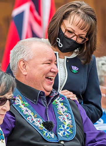 MIKAELA MACKENZIE / WINNIPEG FREE PRESS

Manitoba Metis Federation (MMF) president David Chartrand laughs while signing multiple copies of the agreement, which gives the MMF formal recognition to lead the Manitoba Metis and represent them, as MMF vice president Leah LaPlante (left) and Chartrand's wife, Glorian Chartrand, watch at a signing ceremony at Upper Fort Garry Heritage Provincial Park in Winnipeg on Tuesday, July 6, 2021. For Carol Sanders story.
Winnipeg Free Press 2021.