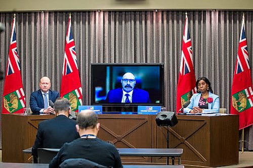 Dr. Brent Roussin, chief provincial public health officer (left), health system co-lead of the Unified Health Sector Incident Command Dr. David Matear (on screen), and Health Minister Audrey Gordon speak to media at a press conference in Winnipeg Friday. (Mikaela Mackenzie/Winnipeg Free Press)