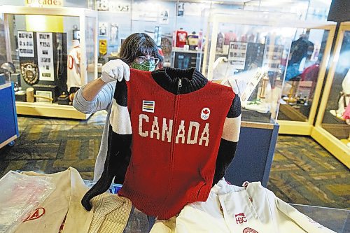 MIKE DEAL / WINNIPEG FREE PRESS
Andrea Reichert, curator at the Manitoba Sports Hall of Fame &amp; Museum, with artifacts from previous winter Olympics.
A sweater worn by an athlete to the 2014 Winter Olympics.
See Brenda Suderman story
220125 - Tuesday, January 25, 2022.