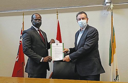 Coun. Sunday Frangi and Mayor Rick Chrest showcase the first ever proclamation signed by Brandon city council to acknowledge February as Black History Mont in the city. (Joseph Bernacki/The Brandon Sun)