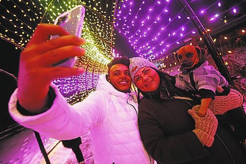 JOHN WOODS / WINNIPEG FREE PRESS

Ariane Bruyere and Khalil Ouertani snap a picture with their pup Chewy as they enjoy the light display by walking throughout The Forks, Monday, January 3, 2022. The young couple were celebrating their first wedding anniversary and Khalil&#x2019;s recent arrival from Tunisia in Winnipeg. The couple met online and couldn&#x2019;t be together because of visa and COVID delays.



Re: Standup