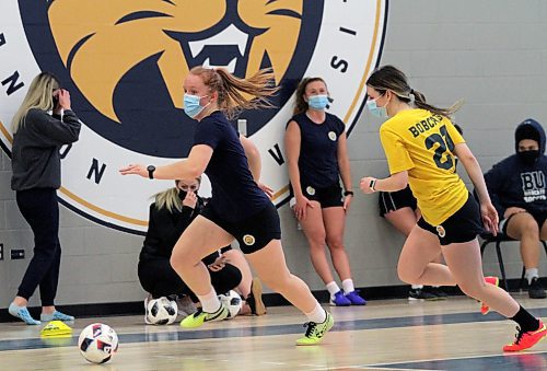 Helen Langrehr, left, dribbles past Ashley Robinson during Brandon University women's futsal practice at the Healthy Living Centre on Wednesday. (Thomas Friesen/The Brandon Sun)