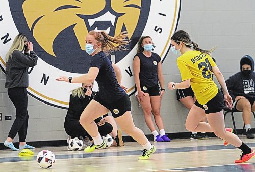 Helen Langrehr, left, dribbles past Ashley Robinson during Brandon University women's futsal practice at the Healthy Living Centre on Wednesday. (Thomas Friesen/The Brandon Sun)