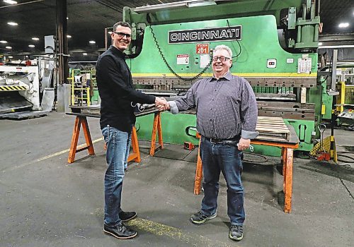 Sean Behlen, VP of Behlen Industries (left) congratulates Vince Goldstone on reaching 50 years of work at the company before Goldstone's retirement on Feb. 7, 2022. (Joseph Bernacki/The Brandon Sun)