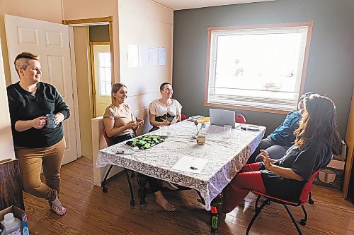 Katimavik participants sit at the kitchen table in their house on Friday. (Chelsea Kemp/The Brandon Sun)