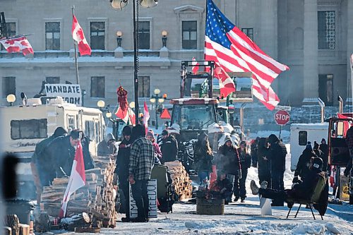 MIKE DEAL / WINNIPEG FREE PRESS

Protesters stack firewood donated for the fire pits that have sprouted up along Memorial Boulevard. They continue to block the entrance to the Manitoba Legislative building on Broadway early Monday morning. The mandate protesters, who have been set up along Memorial Boulevard since Friday morning, now have access to portable toilets and are using fire pits to keep warm.

220207 - Monday, February 07, 2022.