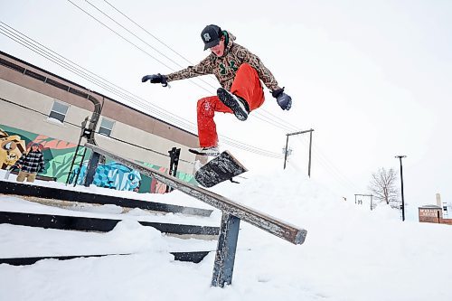 Quintin Kitson of Rapid City heelflips down a set of stairs at the Kristopher Campbell Memorial Skatepark in Brandon while snow-skating with his brother Tanner on a mild Monday. (Tim Smith/The Brandon Sun)