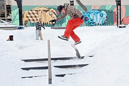 Quintin Kitson of Rapid City heelflips down a set of stairs at the Kristopher Campbell Memorial Skatepark in Brandon while snow-skating with his brother Tanner on Monday. (Tim Smith/The Brandon Sun)