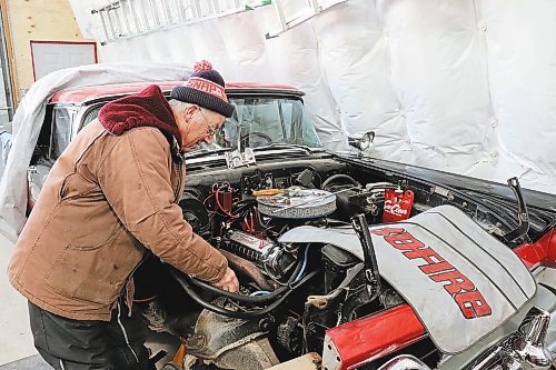 Lothar Weber tunes up his 1957 Ford Fairlane Skyliner on Wednesday morning in Westman. The 74-year-old told the Sun that he finally tracked this rare retractable car down in 2012 after looking for it for most of his adult life. (Kyle Darbyson/The Brandon Sun)