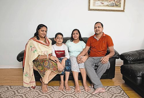 Sreeti Rani Barman, Sattik, 11, Saptorshi, 14, and Subir Barman pose for a photograph at their home in Mississauga, Ont., on Wednesday, Mar. 18, 2022.  Subir crossed the border from the US into Emerson five years ago and was recently joined by the rest of his family. TIJANA MARTIN/ WINNIPEG FREE PRESS