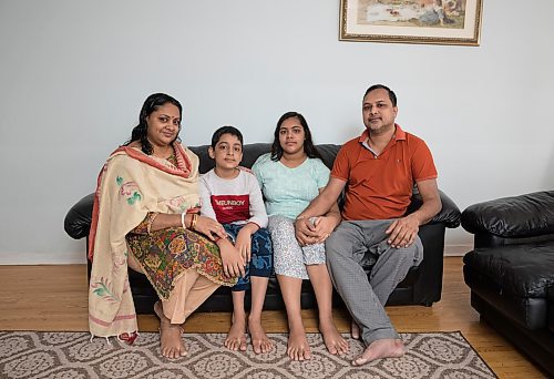 Sreeti Rani Barman, Sattik, 11, Saptorshi, 14, and Subir Barman pose for a photograph at their home in Mississauga, Ont., on Wednesday, Mar. 18, 2022.  Subir crossed the border from the US into Emerson five years ago and was recently joined by the rest of his family. TIJANA MARTIN/ WINNIPEG FREE PRESS