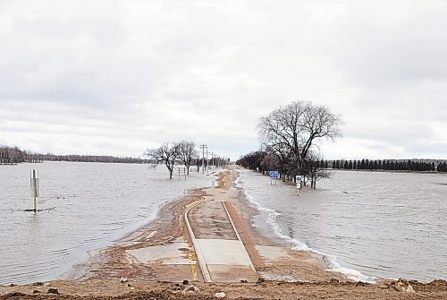 Brandon Sun Floodwater begins to recede off Grand Valley Road on Sunday; a roadway that floods over at 1,176.5 feet above sea level. (Tyler Clarke/The Brandon Sun)