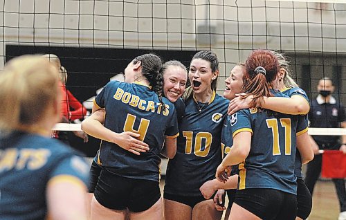 The Brandon University Bobcats celebrate their five-set win over the Winnipeg Wesmen in Canada West women's volleyball action at the Duckworth Centre on Saturday. (Thomas Friesen/The Brandon Sun)