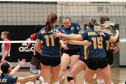 The Brandon University Bobcats celebrate their five-set win over the Winnipeg Wesmen in Canada West women's volleyball action at the Duckworth Centre on Saturday. (Thomas Friesen/The Brandon Sun)