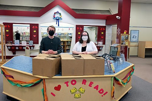 Programming librarian Alex Rogowsky and library clerk Paige Bender show off some of the books being packed up at the Western Manitoba Regional Library's downtown branch for delivery to the library's expanded Shoppers Mall location. (Colin Slark/The Brandon Sun)