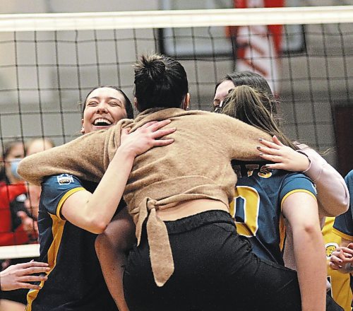 Rayvn Wiebe, left, celebrates the win that guaranteed her a .500-or-better record for the first time in her Canada West women's volleyball career at the Duckworth Centre on Saturday. (Thomas Friesen/The Brandon Sun)