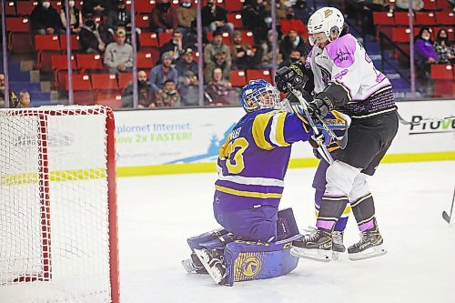 25022022
Landon Roberts #22 of the Brandon Wheat Kings collides with goalie Nolan Maier #73 of the Saskatoon Blades during WHL action at Westoba Place on Friday evening. (Tim Smith/The Brandon Sun)