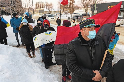 Oleksander Brianskyi, holding the Congress of Ukrainian Nationalism flag, gathers with other community members in front of Brandon City Hall Friday in support of Ukraine. The country was invaded by Russian forces Thursday. (Chelsea Kemp/The Brandon Sun)