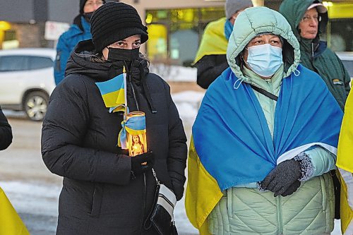 Community members gather in front of Brandon City Hall Friday in support of Ukraine. The country was invaded by Russian forces Thursday. (Chelsea Kemp/The Brandon Sun)